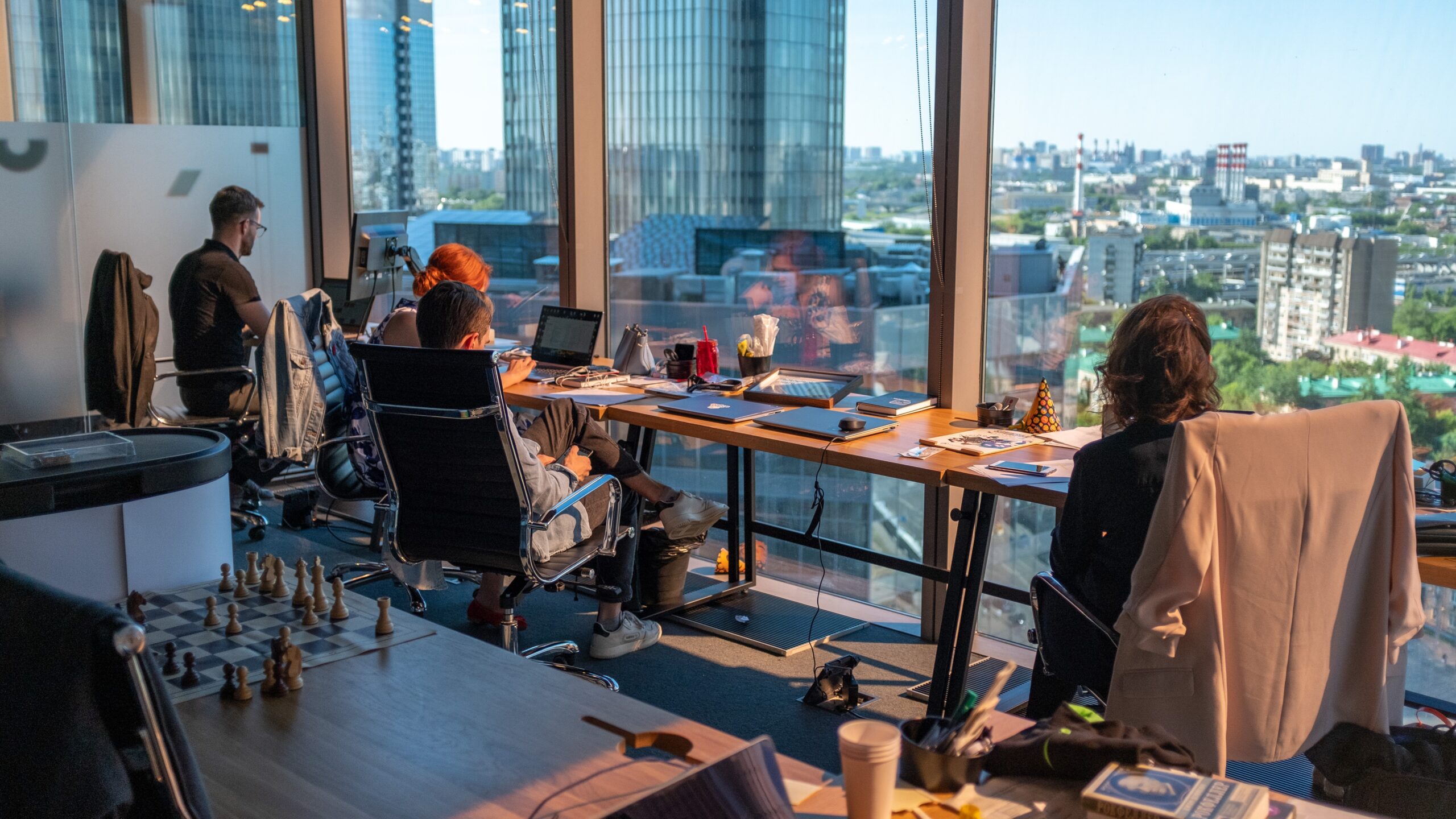 An office in a highrise with a view of the city with workers