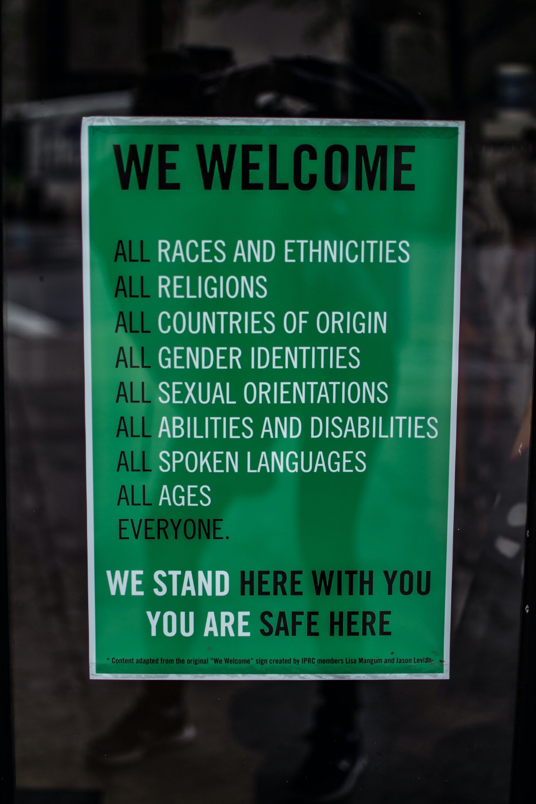 image of sign that reads "We welcome all races and ethnicities, all religions, all countries of origin, all gender identities, all sexual orientations, all abilities and disabilities, all spoken languages, all ages, everyone. We stand here with you. You are safe here"